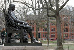 Photo taken in Harvard Yard, foregrounding the famous John Harvard statue