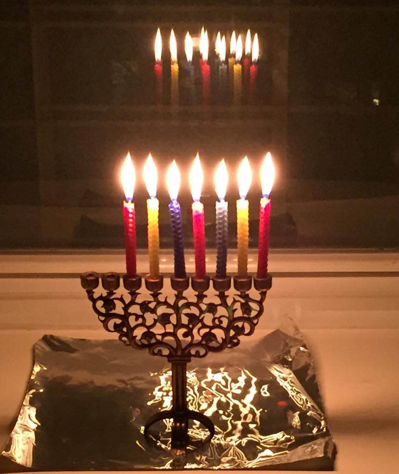 A Hanukkah menorah with most (but not all!) candles lit.